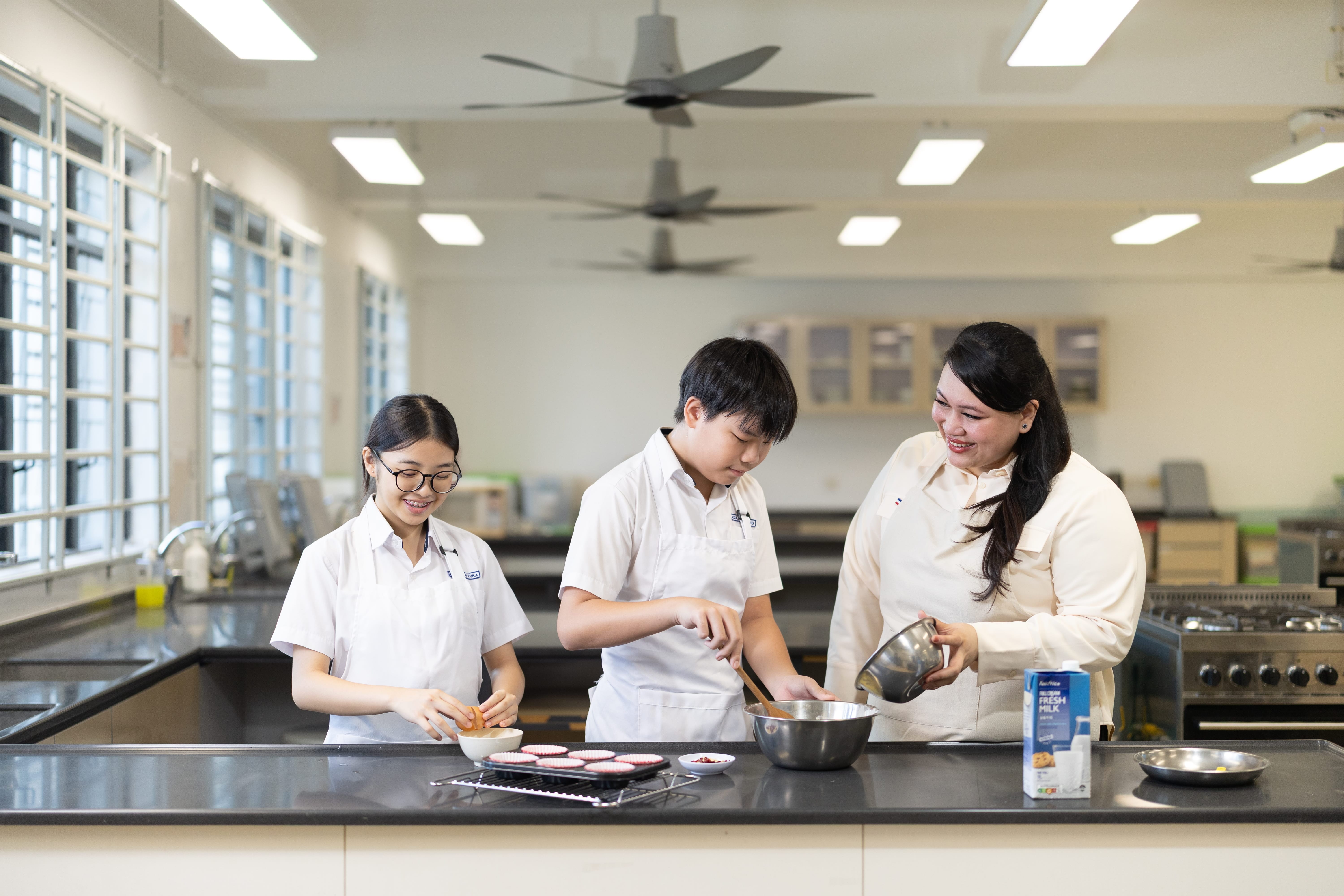 Teacher teaching students how to bake.